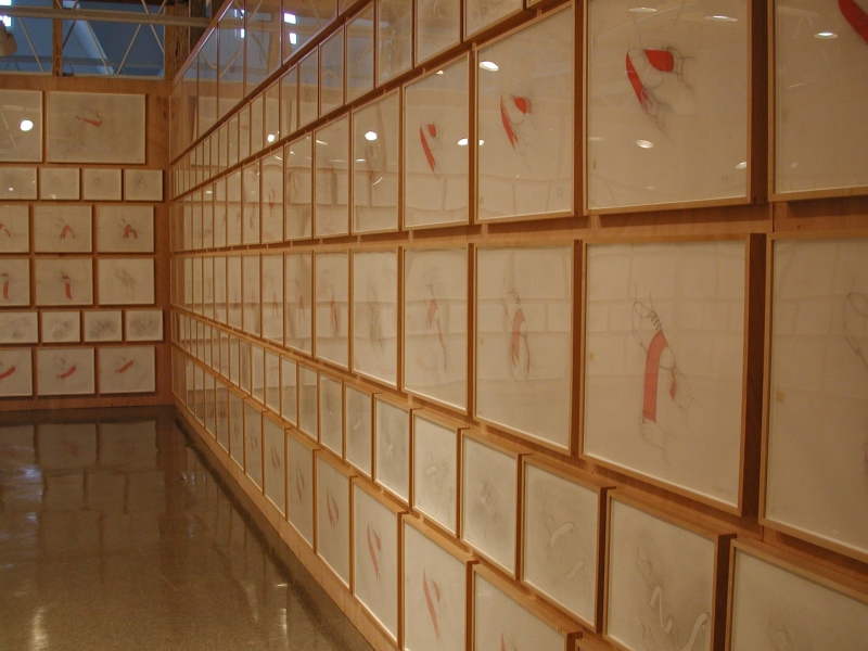 Wooden walls covered in rectangular drawings of various sizes